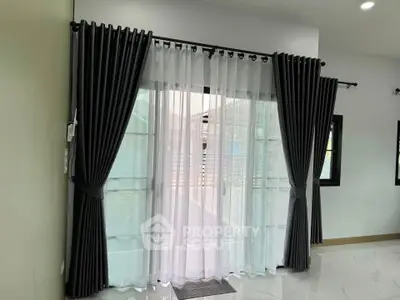 Elegant living room with modern curtains and large window view