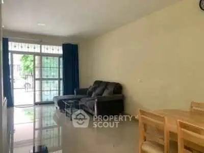 Spacious living room with modern furniture and large windows for natural light.