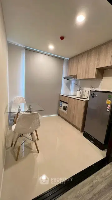 Modern compact kitchen with sleek appliances and dining area