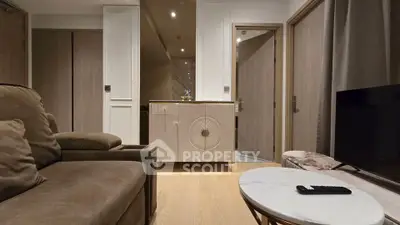 Modern living room with cozy sofa and sleek TV setup, featuring elegant decor and ambient lighting.
