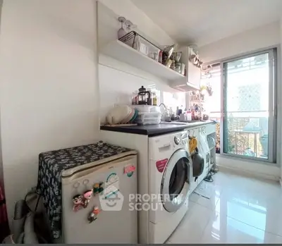 Bright kitchen with washing machine and balcony access, ideal for modern living.