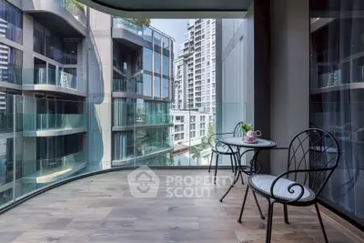 Luxurious balcony with stunning city view and elegant seating area in modern high-rise building.