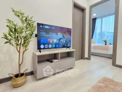 Modern living room with sleek TV stand and cozy bedroom view, perfect for stylish urban living.