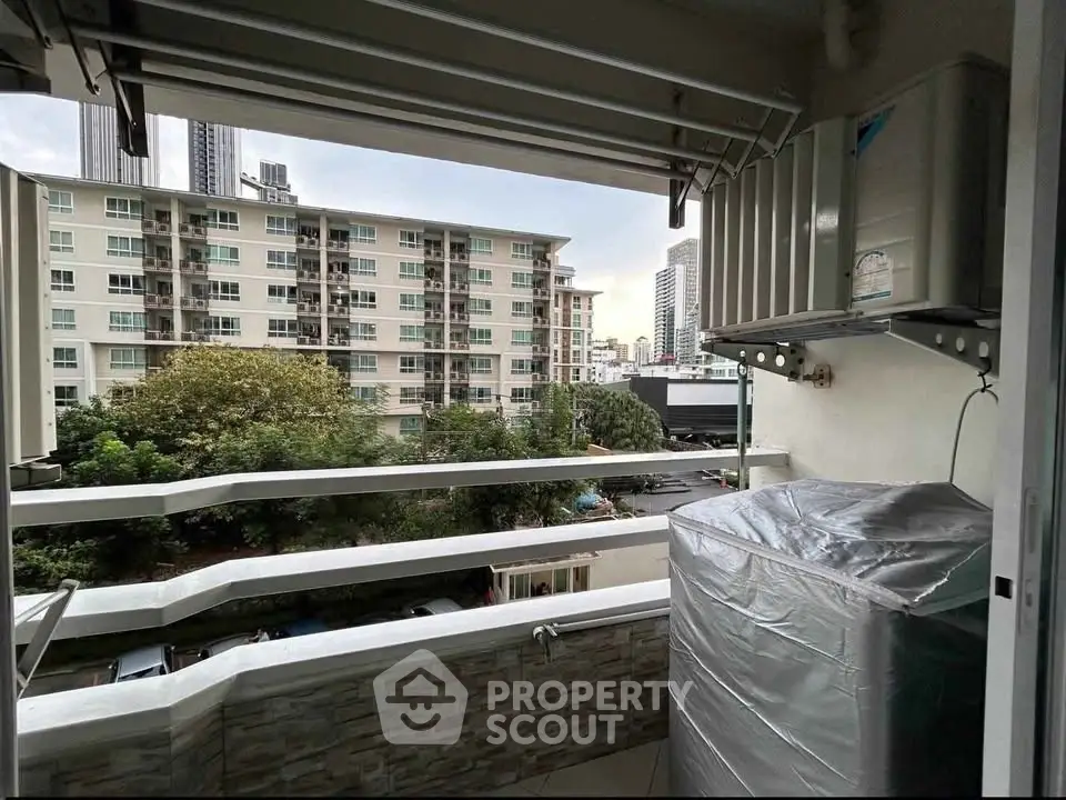 Charming balcony view with cityscape backdrop, perfect for urban living enthusiasts seeking a serene outdoor space.