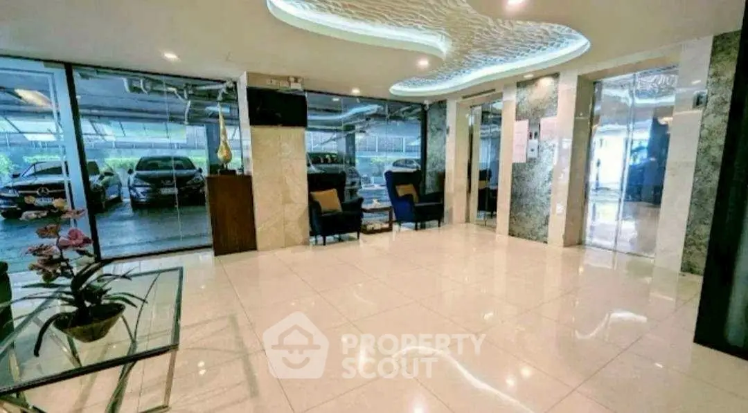 Elegant building entrance with modern decor and ample natural light.
