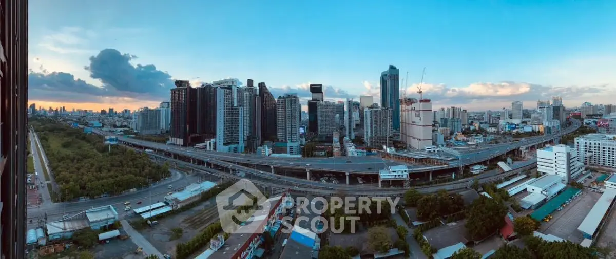 Stunning panoramic cityscape view with modern skyscrapers and vibrant skyline at sunset.