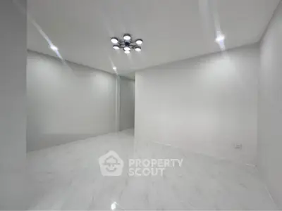 Spacious minimalist room with modern lighting and sleek white flooring