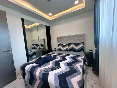 Modern bedroom with stylish decor and mirrored wardrobe