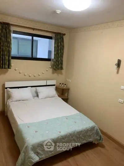 Cozy bedroom with double bed and decorative string lights, ideal for restful nights.