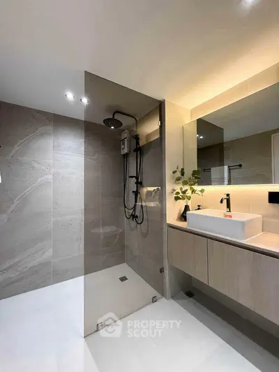 Modern bathroom with sleek shower and elegant vanity in contemporary design.