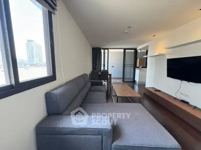 Spacious modern living room with city view and sleek furnishings