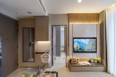Modern living room with stylish decor and built-in TV unit, featuring elegant lighting and contemporary design.