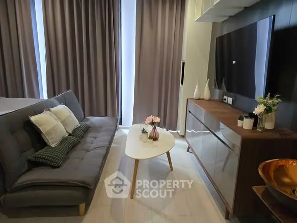 Modern living room with sleek furniture and large TV, perfect for urban living.