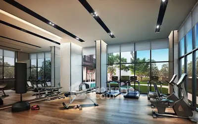 Modern gym with state-of-the-art equipment and large windows offering garden views.