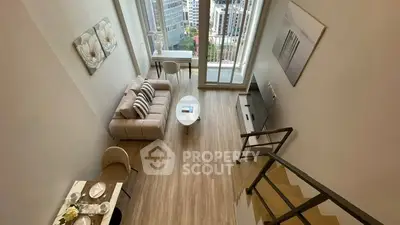 Stunning modern living room with high ceilings and city view from balcony.