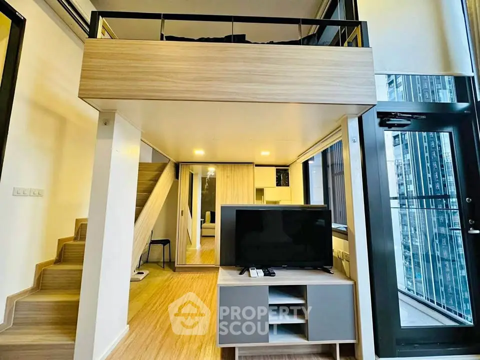 Modern loft apartment with mezzanine, large windows, and stylish interior design.