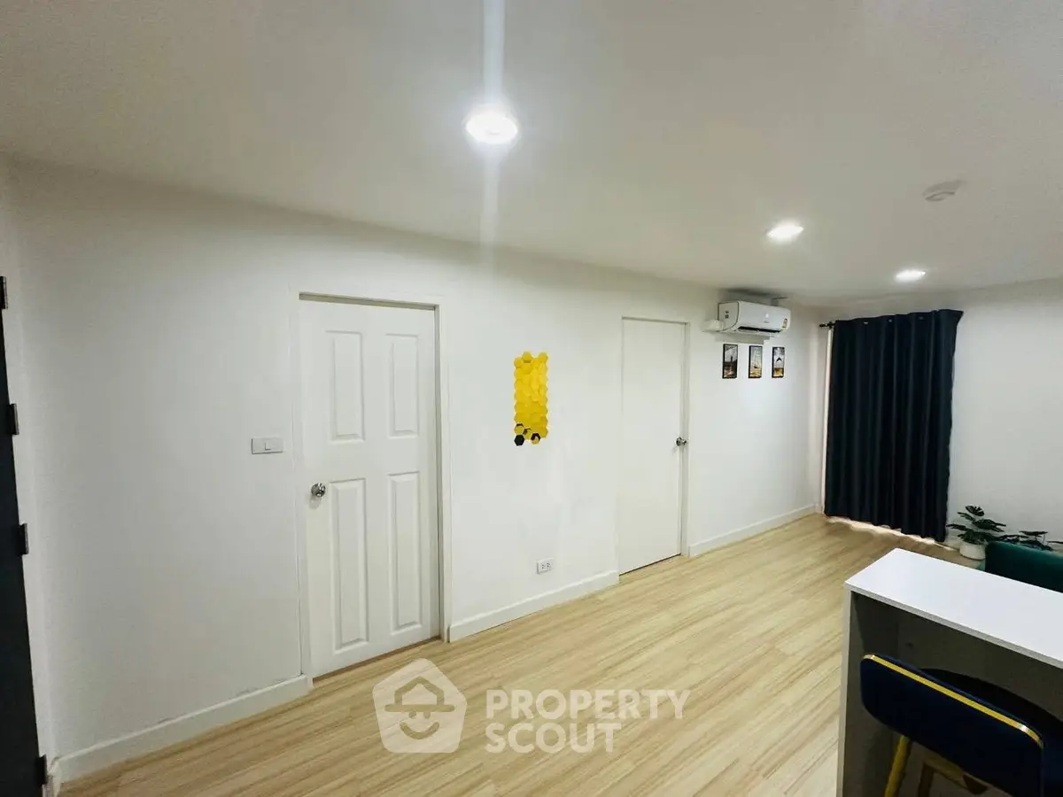 Modern minimalist room with wooden flooring and air conditioning