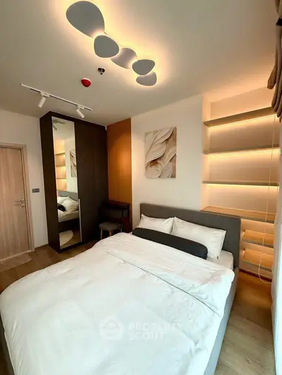 Modern bedroom with stylish lighting and sleek furniture design