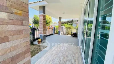 Charming patio with modern tiles and garden view, perfect for relaxation and outdoor enjoyment.