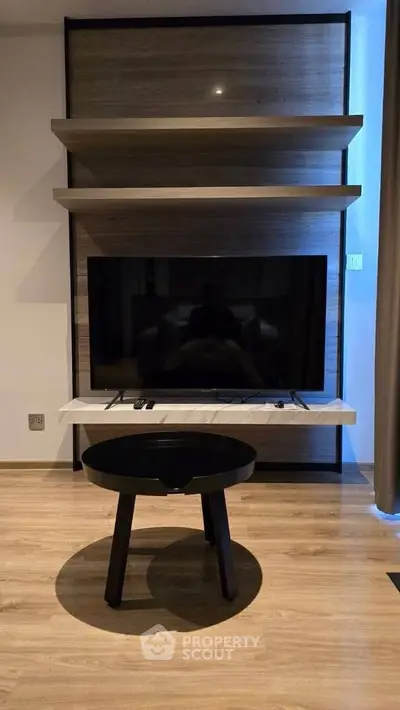 Modern living room with sleek TV setup and stylish wooden shelves