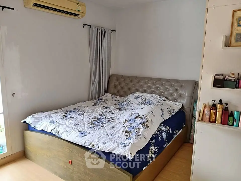 Cozy bedroom with stylish bed and air conditioning, perfect for relaxation and comfort.