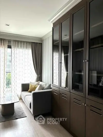 Stylish living room with elegant cabinetry and cozy sofa, perfect for modern urban living.