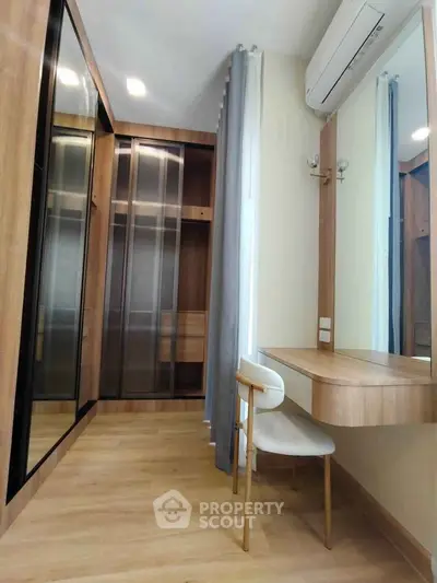 Modern bedroom with stylish wooden wardrobe and cozy vanity area