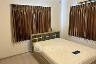 Cozy bedroom with elegant curtains and a comfortable bed, perfect for relaxation.