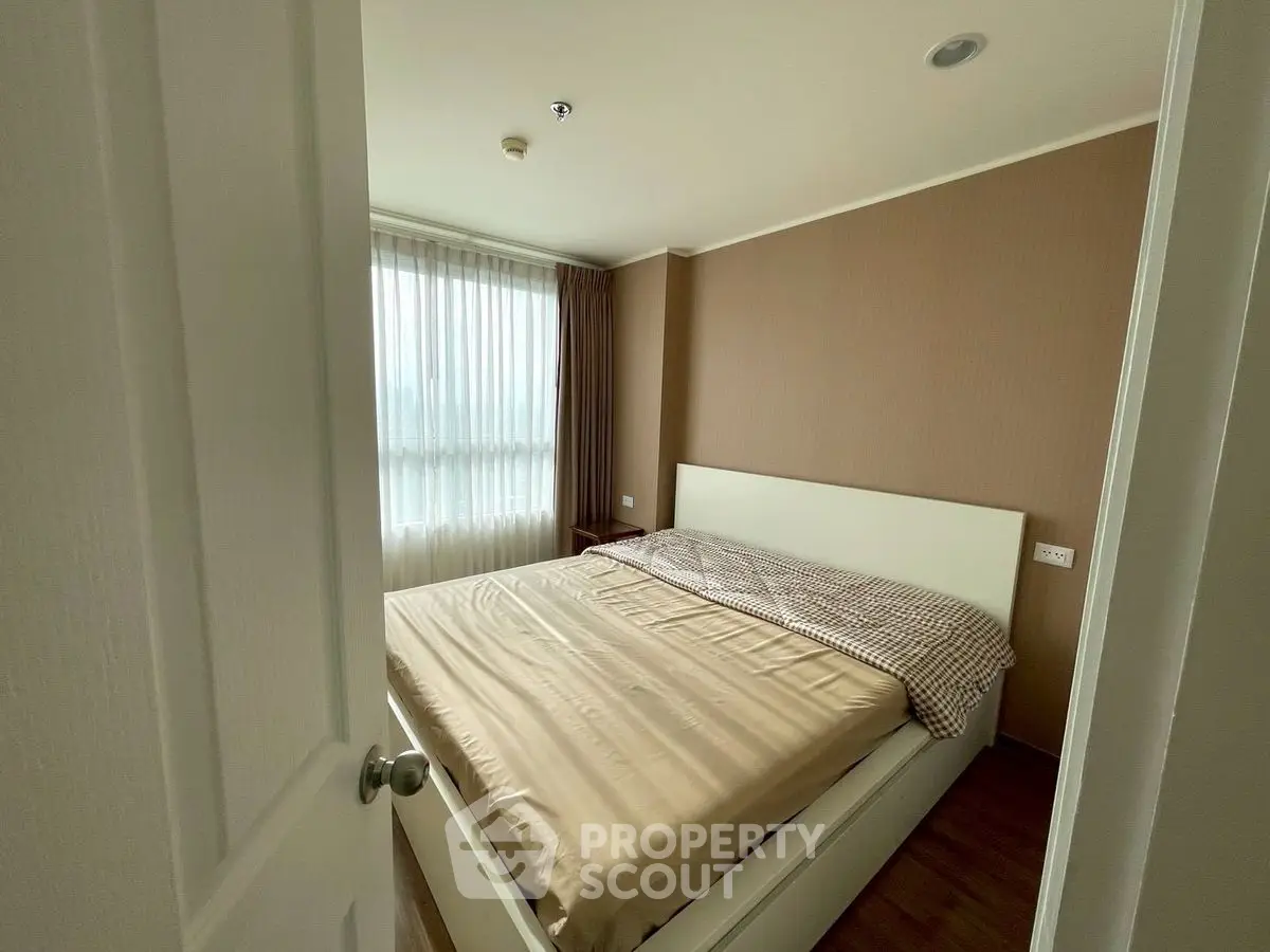 Cozy bedroom with natural light and modern decor, perfect for relaxation.