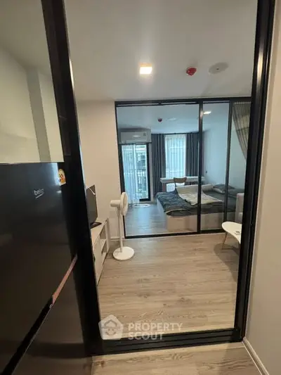 Modern apartment interior with open layout, featuring a cozy bedroom and living area with stylish decor.