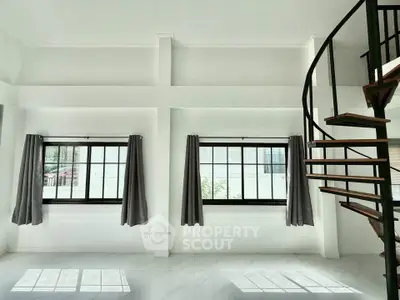 Spacious modern living room with spiral staircase and large windows