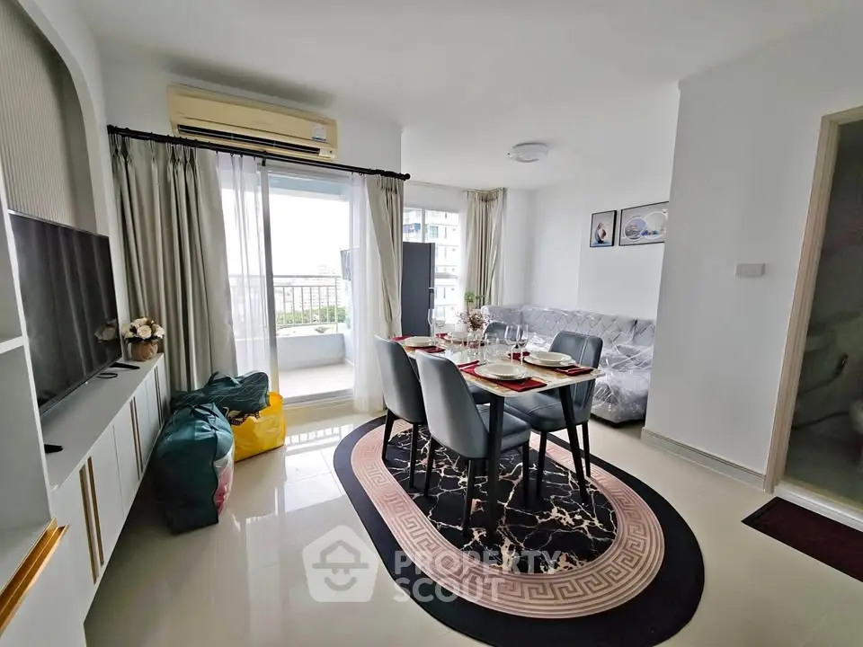 Modern living room with elegant dining setup and balcony view