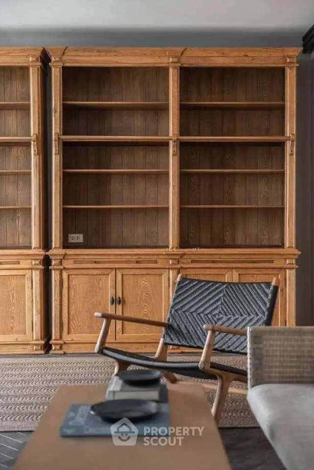 Elegant wooden bookshelves in a cozy living room with stylish furniture.