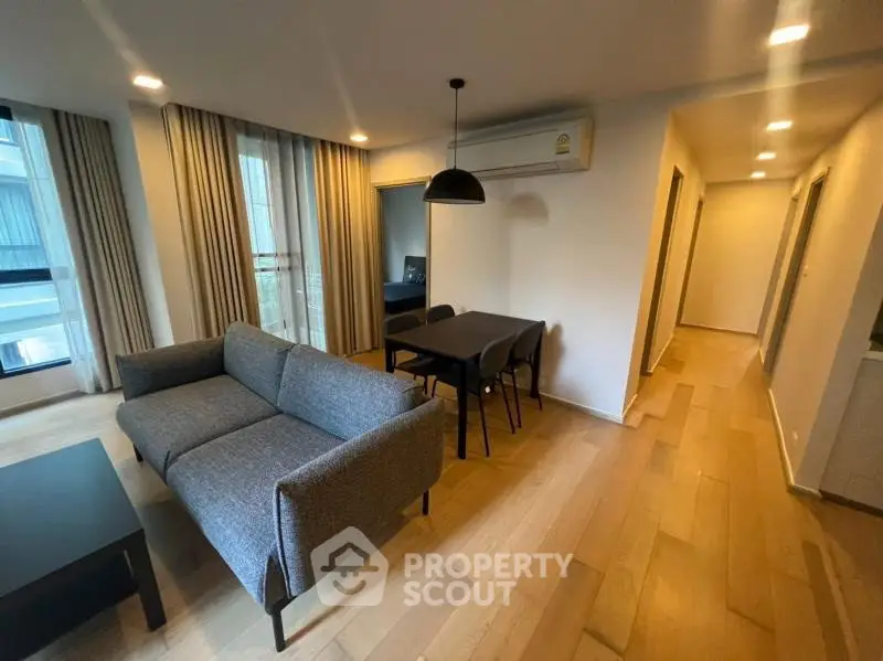 Modern living room with stylish furniture and wooden flooring in a cozy apartment.