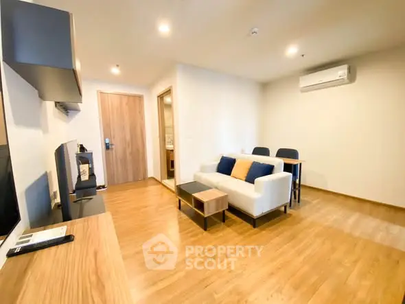 Modern living room with wooden flooring and cozy seating area