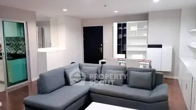 Spacious modern living room with stylish gray sofa and open layout