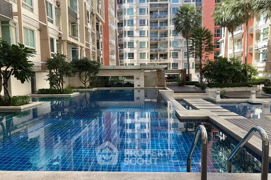 Luxurious condominium with stunning pool and lush greenery in prime location