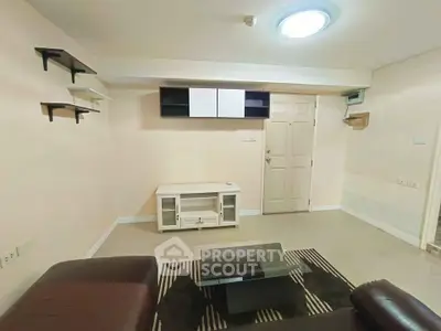 Cozy living room with modern furniture and stylish shelving, perfect for relaxation and entertainment.