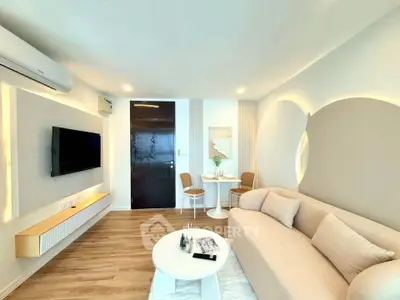 Modern living room with sleek design, featuring a cozy sofa, wall-mounted TV, and stylish dining area.