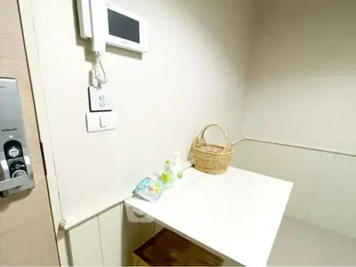 Cozy interior corner with intercom and small table, ideal for compact living spaces.