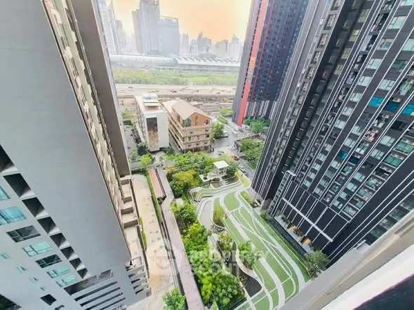 Stunning aerial view of modern high-rise buildings with lush green landscaped gardens below.