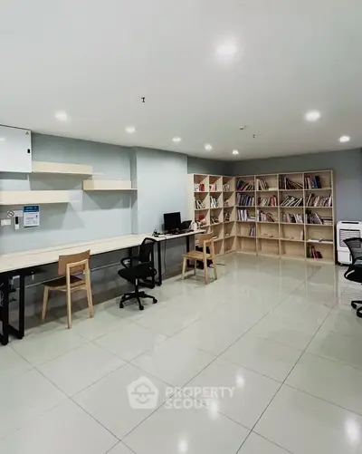 Spacious modern study room with sleek furniture and ample shelving.
