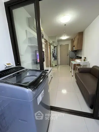 Modern apartment interior with washing machine and cozy living area