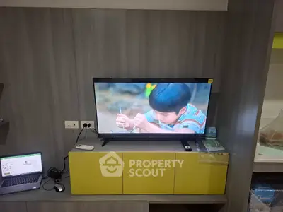 Modern living room with TV and workspace setup