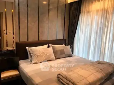 Luxurious bedroom with elegant decor and large window drapes