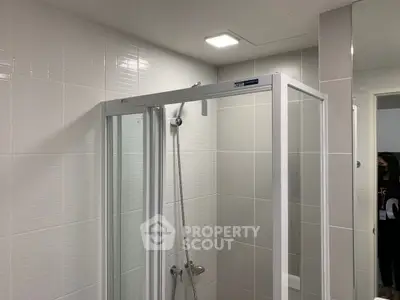 Modern bathroom with sleek shower enclosure and tiled walls