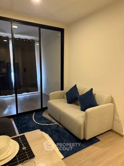 Modern living room with cozy sofa and stylish decor in a contemporary apartment.