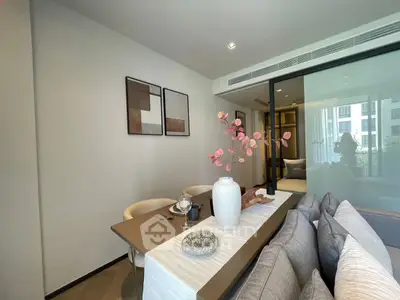 Modern living room with stylish decor and glass partition in a contemporary apartment.