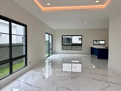 Spacious modern living room with marble flooring and large windows