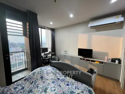 Modern bedroom with balcony and city view, featuring air conditioning and stylish decor.